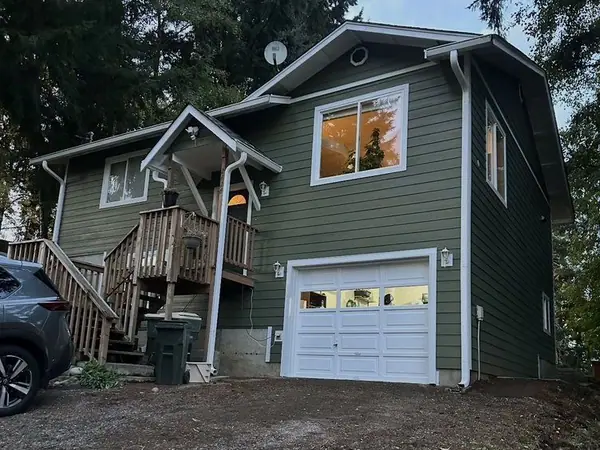 Two-story home with new sage green Hardie siding and white trim